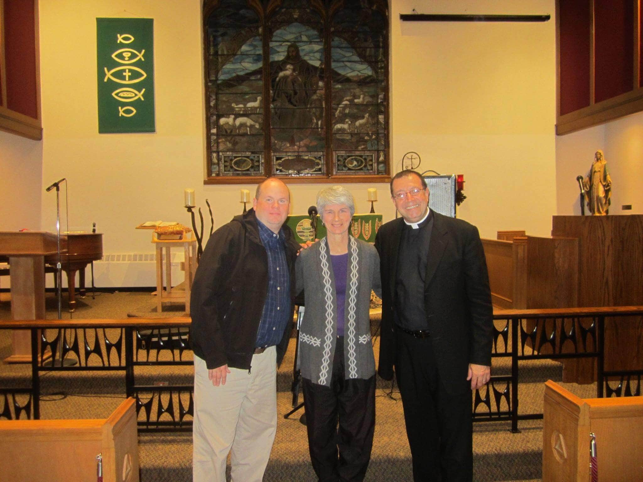 Community leader with clergy and congregation members in church.